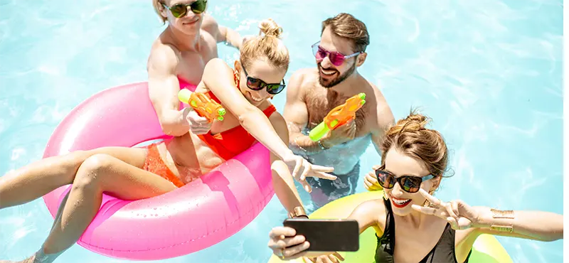 FAU students laughing in University Park pool