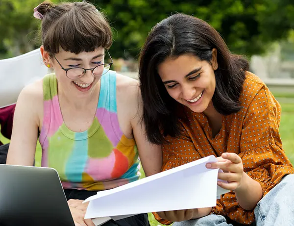 Two FAU students working on a project in the turf