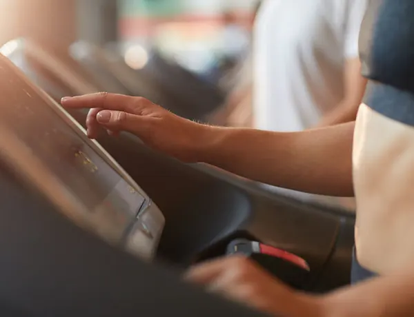 Student running on treadmill in the fitness center